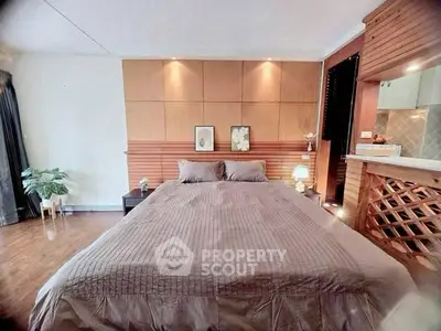 Spacious bedroom with modern decor and cozy ambiance