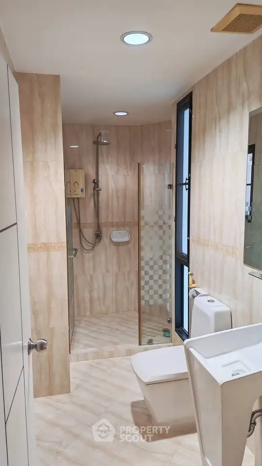 Modern bathroom with glass shower and sleek fixtures