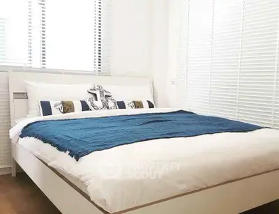Cozy bedroom with nautical-themed decor and bright natural light
