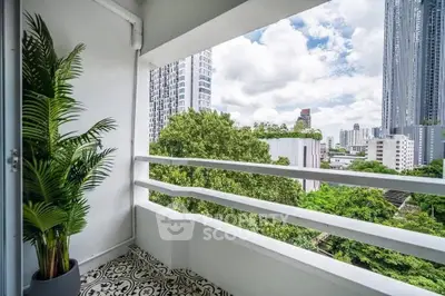 Charming balcony with city skyline view and lush greenery, perfect for relaxation.