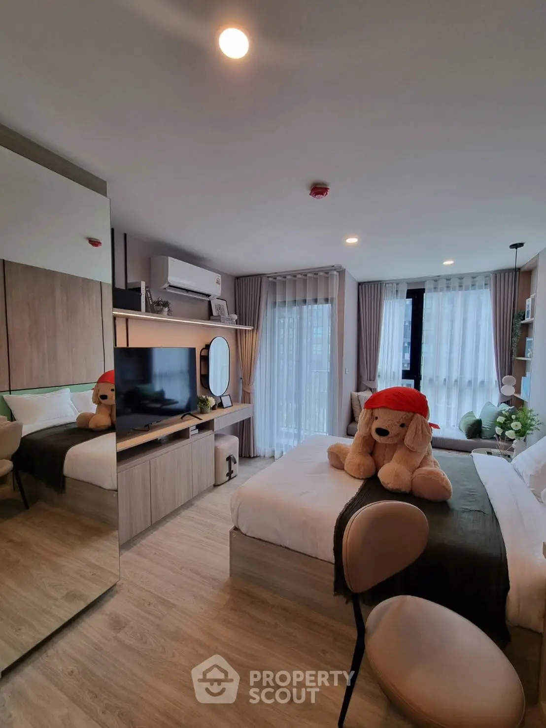 Modern bedroom with plush decor and natural light
