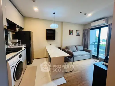 Modern open-layout kitchen and living room with washing machine and balcony view.