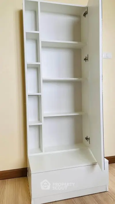 Modern white storage cabinet with open shelves and sleek design, perfect for organizing any room.