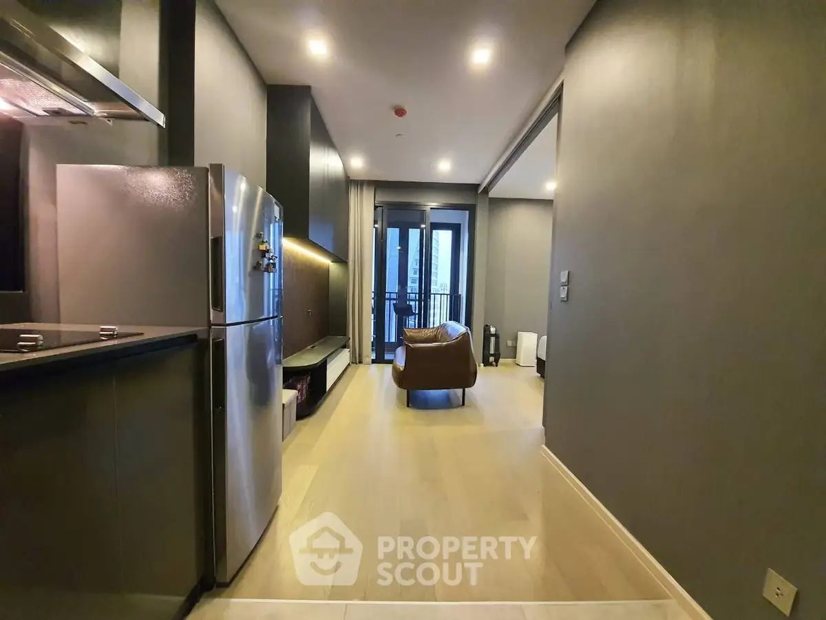 Modern open-layout living room with sleek kitchen and balcony view