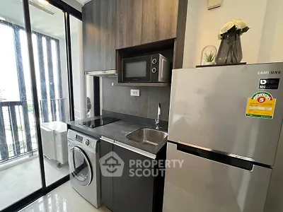 Modern compact kitchen with appliances and balcony view