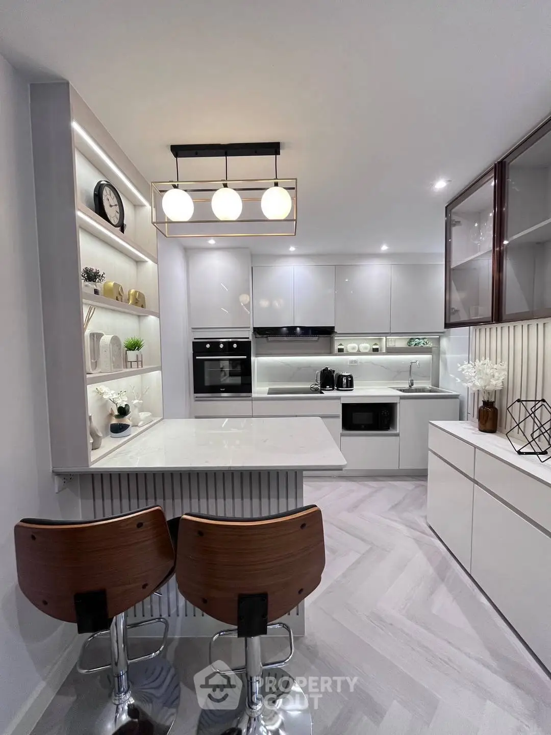 Modern kitchen with sleek white cabinets and breakfast bar seating