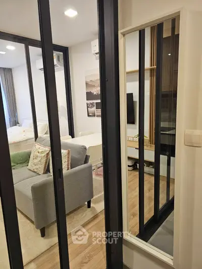 Modern apartment interior with sliding glass doors, cozy living area, and stylish decor.