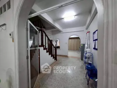 Spacious interior hallway with staircase and water dispenser, ideal for family living.