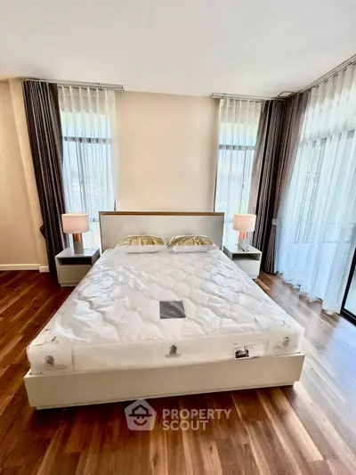 Luxurious bedroom with elegant decor and large windows for natural light