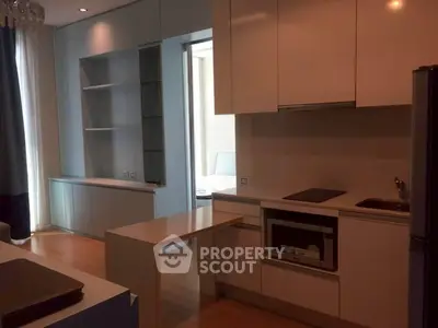 Modern kitchen with sleek cabinetry and integrated appliances in a stylish apartment.