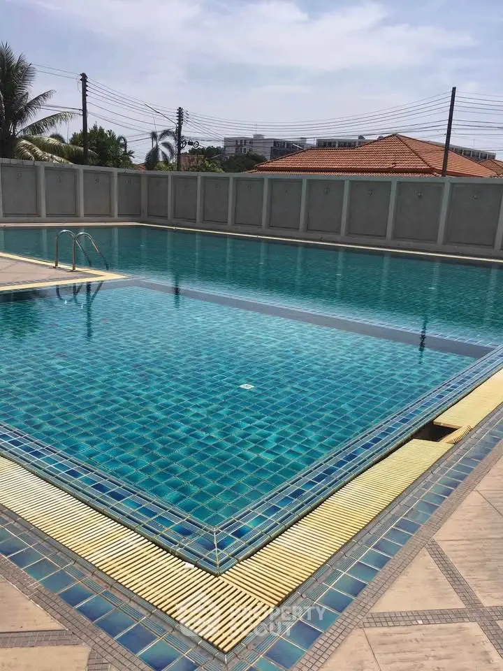Luxurious outdoor swimming pool with clear blue water and elegant tile design, perfect for relaxation and leisure.