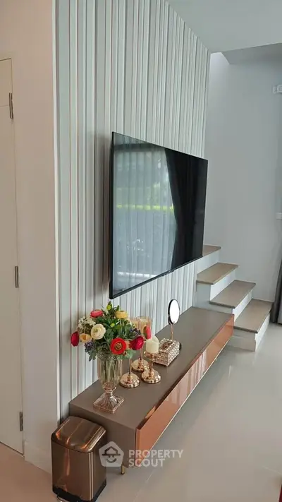 Modern living room with sleek TV setup and elegant decor
