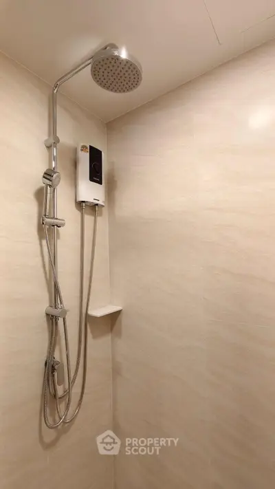 Modern bathroom with sleek shower fixtures and neutral tile design