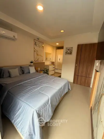 Cozy bedroom with modern decor and ample natural light
