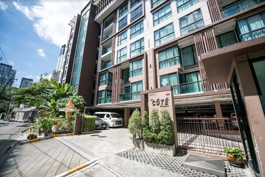 Modern urban condominium with lush greenery and secure parking in prime city location.