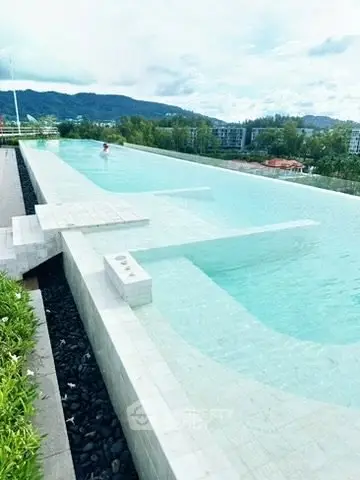 Luxurious rooftop infinity pool with stunning mountain views in a modern residential complex.