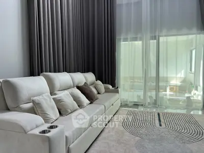 Luxurious living room with elegant curtains and plush sofa, perfect for relaxation and entertainment.
