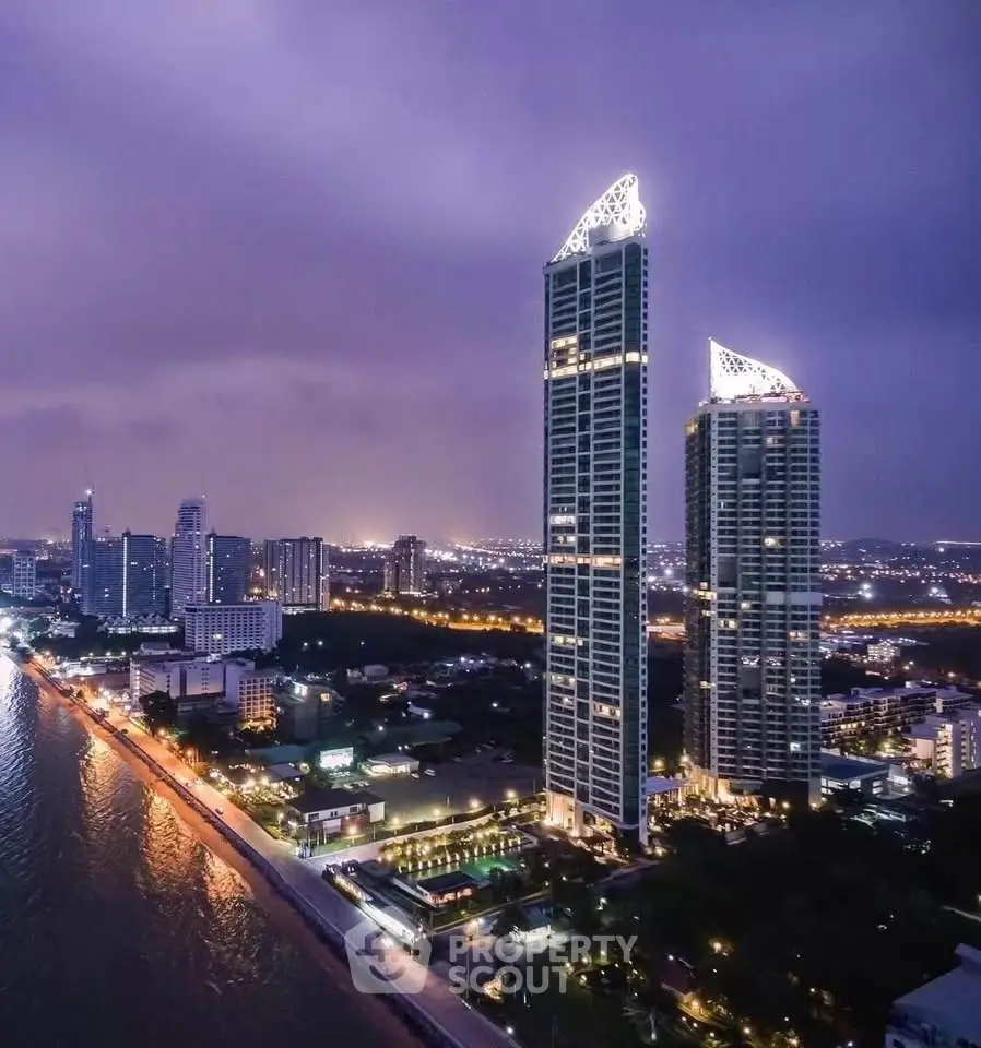 Stunning high-rise waterfront buildings with city skyline view at dusk, perfect for luxury living.
