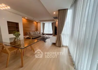 Spacious modern living room with large windows and elegant decor