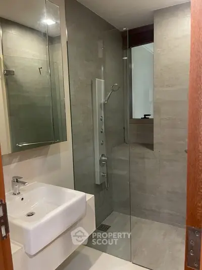 Modern bathroom with sleek shower and stylish sink in contemporary design.