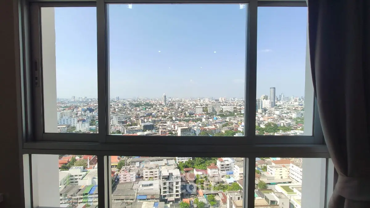 Stunning cityscape view from high-rise apartment window, showcasing urban skyline.