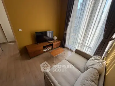 Cozy living room with modern furniture and large window offering city view