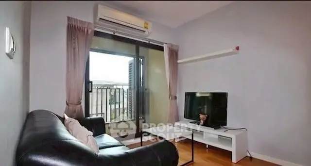 Cozy living room with balcony access and modern furnishings