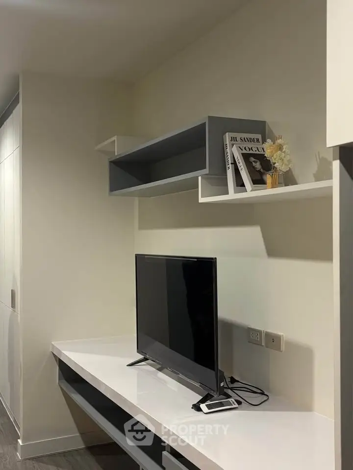 Modern living room with sleek TV setup and stylish shelving, perfect for contemporary urban living.