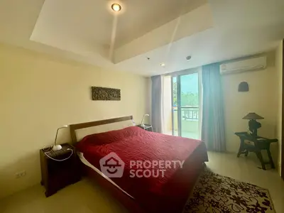 Spacious bedroom with balcony access and elegant decor in a modern apartment.