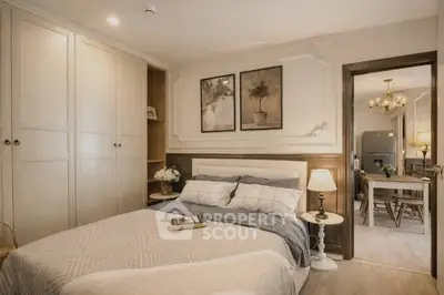 Elegant bedroom with cozy decor and view into stylish dining area.