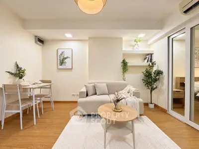 Chic modern living room with cozy sofa, dining area, and stylish decor in bright apartment.