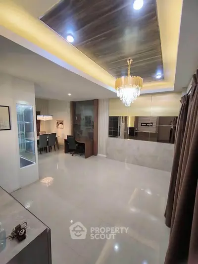 Elegant living room with chandelier and modern dining area