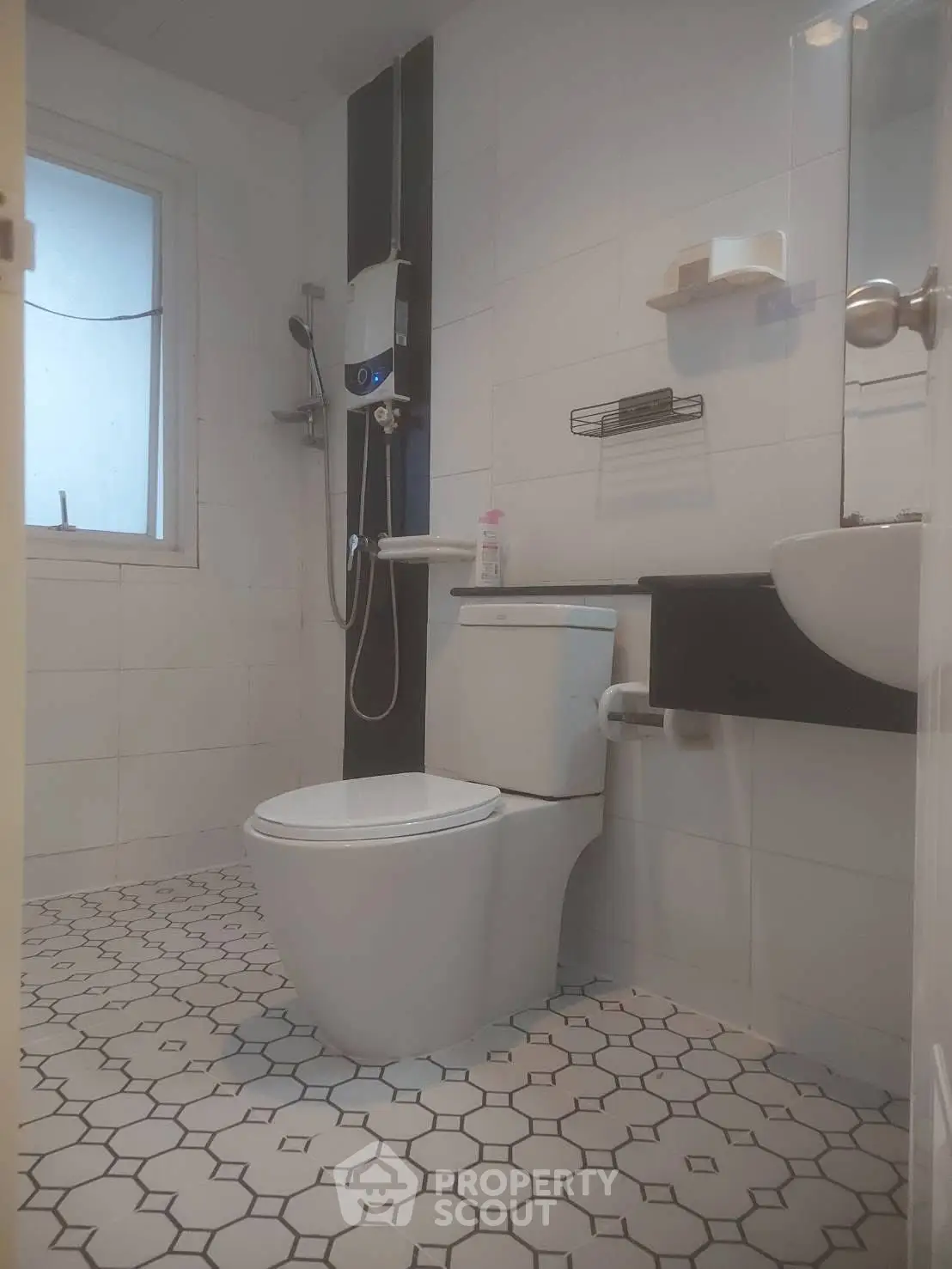 Modern bathroom with sleek fixtures and geometric tile flooring