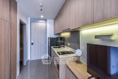 Modern kitchen with sleek cabinetry and integrated appliances in a stylish apartment.
