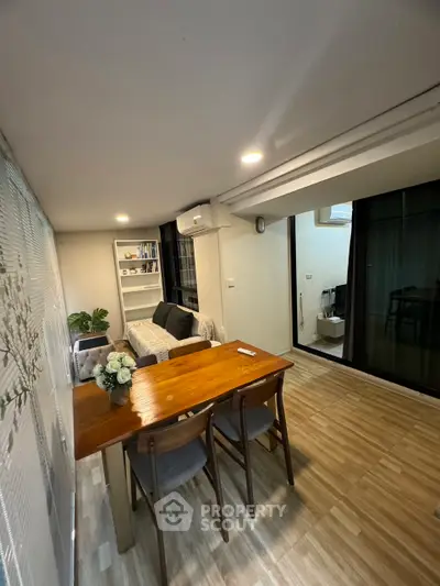 Cozy living room with modern decor and wooden dining table