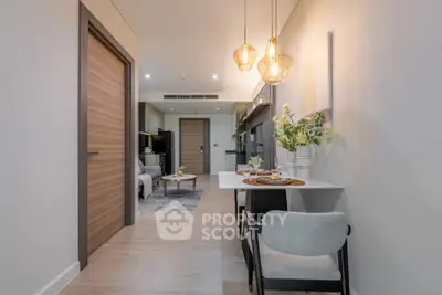 Modern open-plan living area with stylish dining setup and elegant lighting