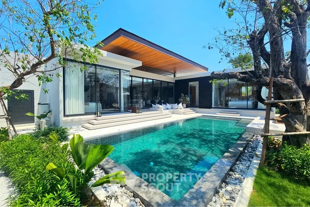 Luxurious modern villa with private pool and lush garden, perfect for serene living.