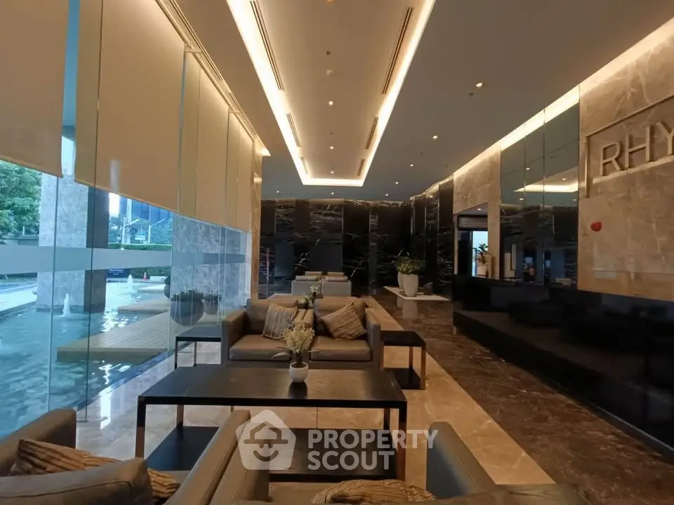Luxurious modern lobby with elegant seating and marble accents in high-end building.