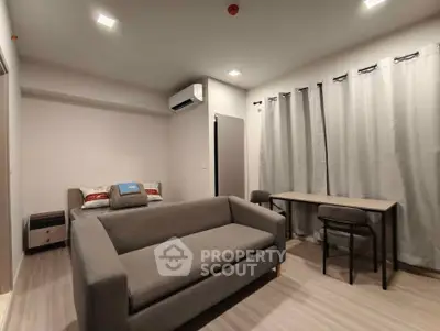Modern studio apartment with cozy living area and stylish furnishings.