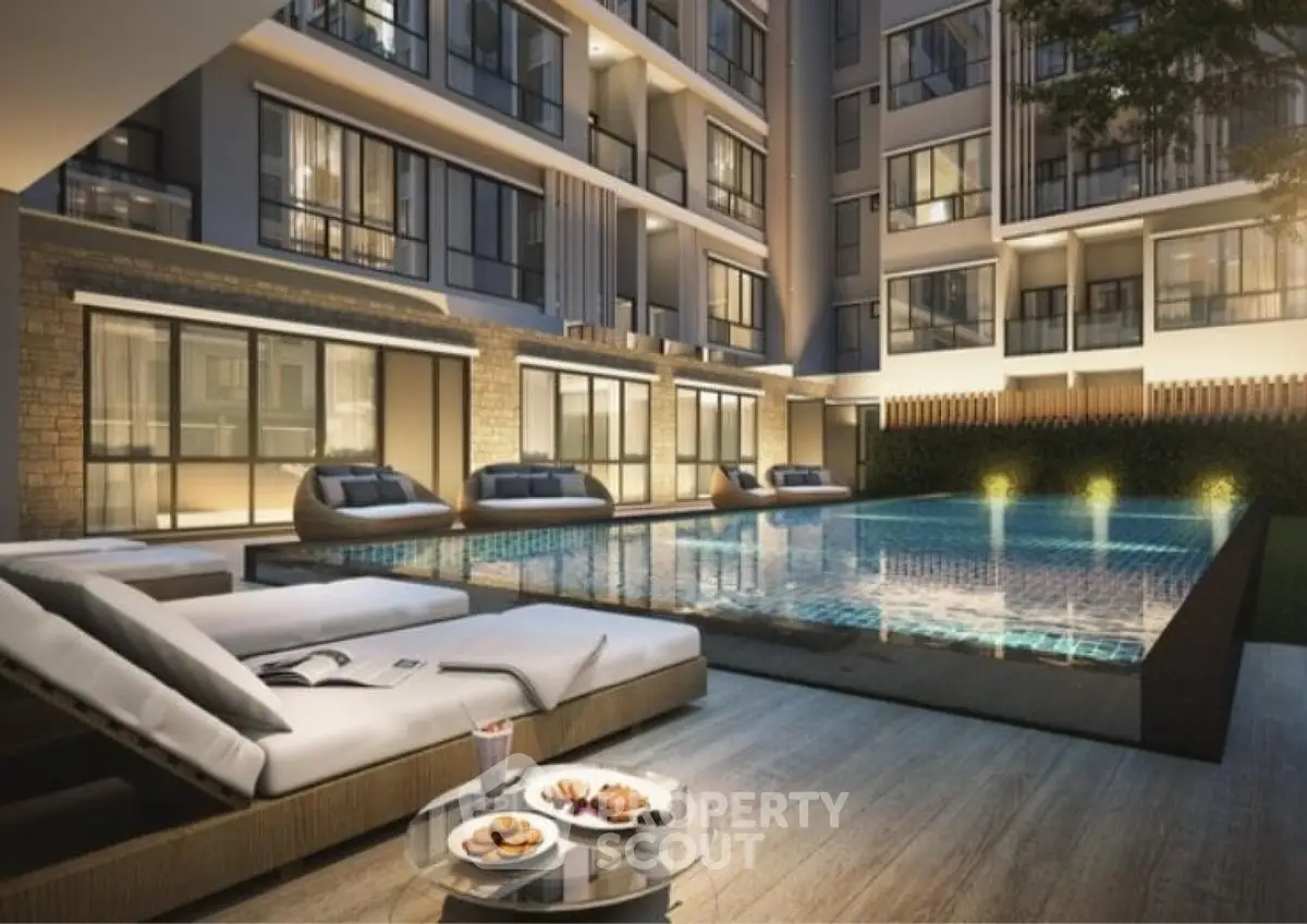 Luxurious apartment complex with illuminated poolside and modern architecture.