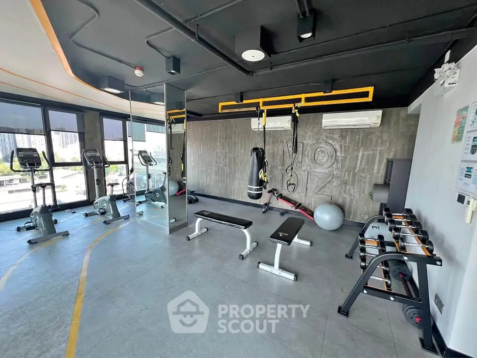 Modern gym with state-of-the-art equipment and city view, perfect for fitness enthusiasts.