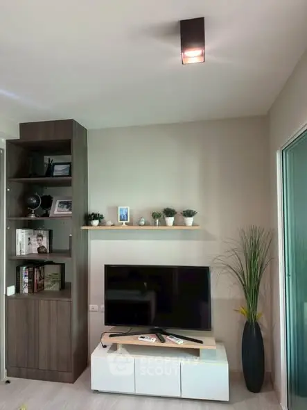 Modern living room with sleek TV setup and stylish shelving