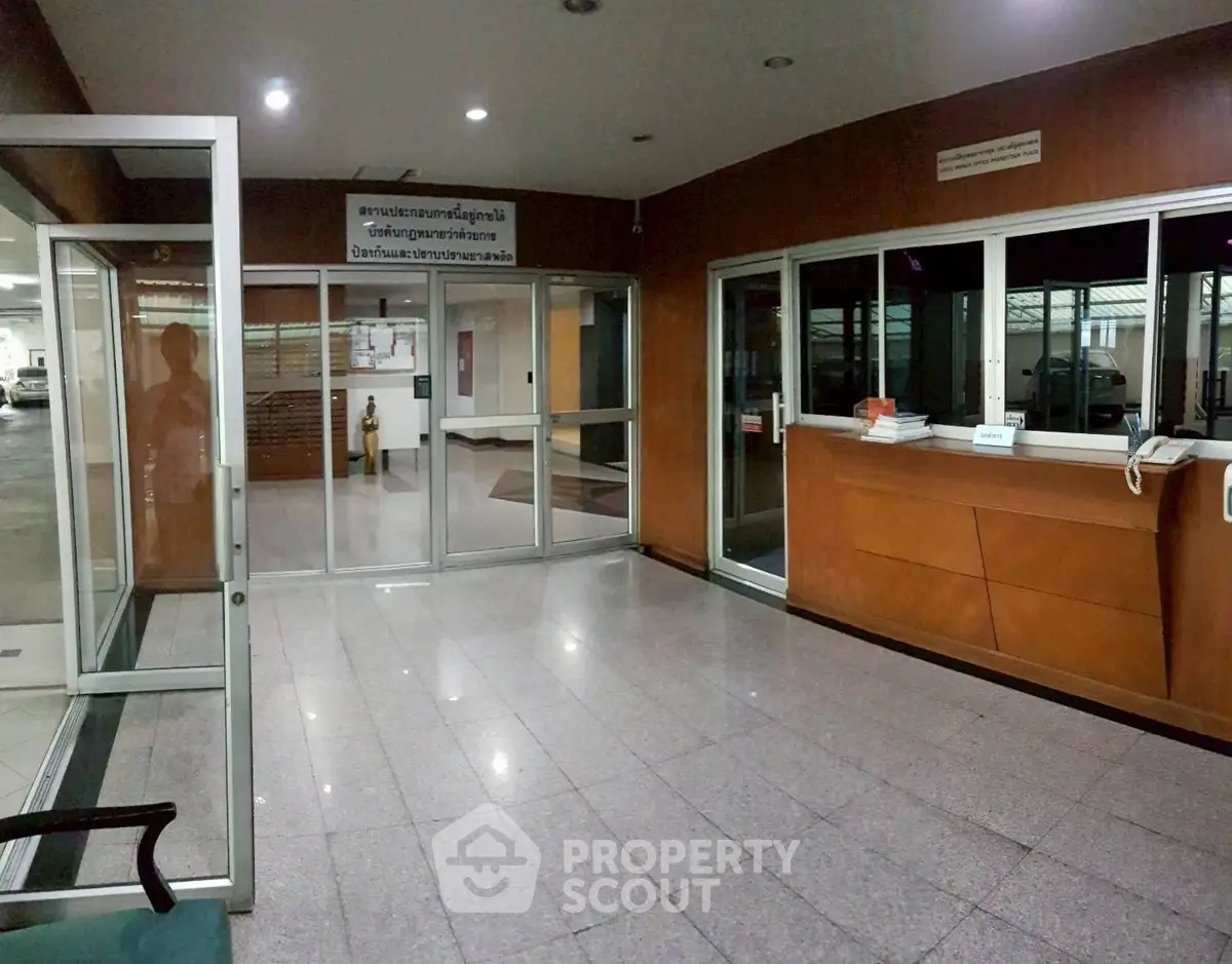 Spacious building entrance with glass doors and reception area
