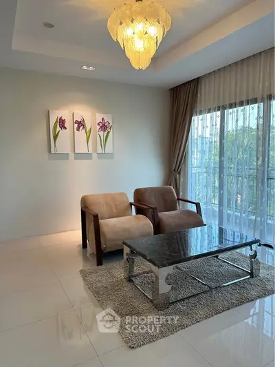 Elegant living room with modern furniture and large windows offering natural light.