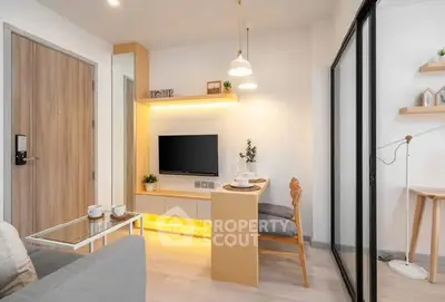 Modern living room with stylish decor and cozy ambiance, featuring a sleek TV unit and elegant lighting.