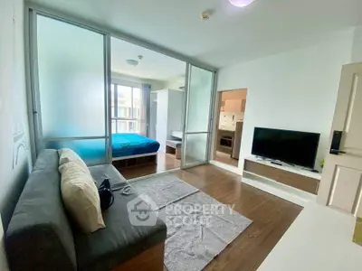 Modern living room with glass partition and cozy bedroom view