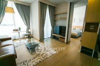 Modern living room with elegant decor and cozy bedroom view.