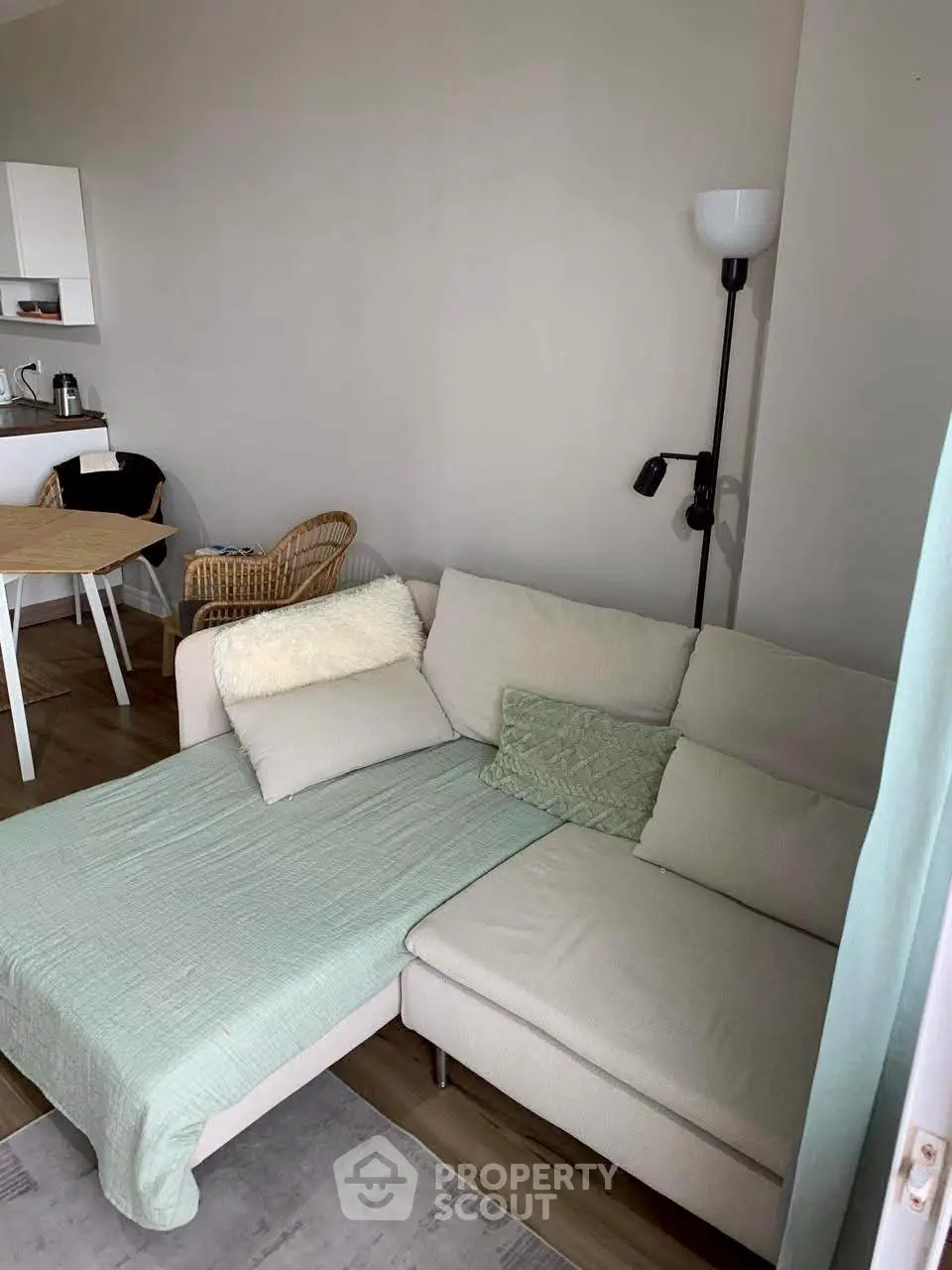 Cozy living room with modern sofa and dining area, perfect for relaxation and entertaining guests.