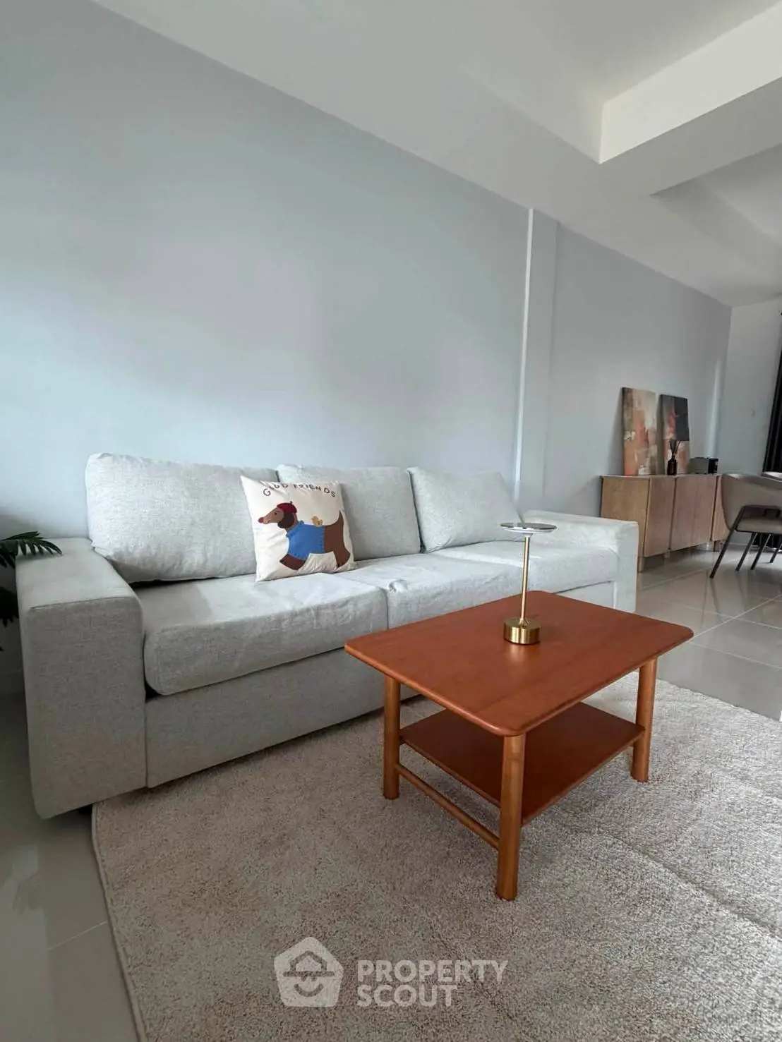 Modern living room with cozy gray sofa and wooden coffee table, perfect for relaxation.