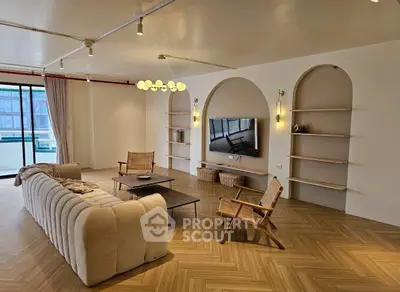 Spacious modern living room with elegant lighting and large windows for natural light.